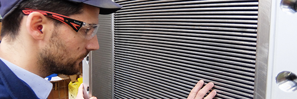 Man inspecting an Alfa Laval Compabloc welded plate heat exchanger